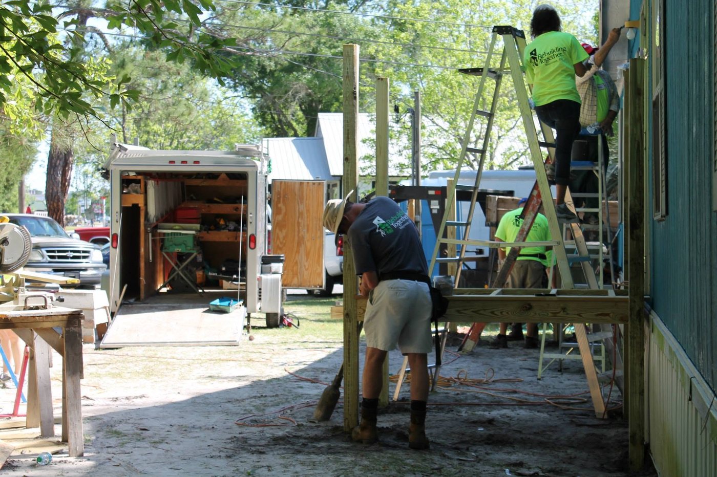 Storm rebuild in Georgia: volunteer crew framing a porch on a damaged home