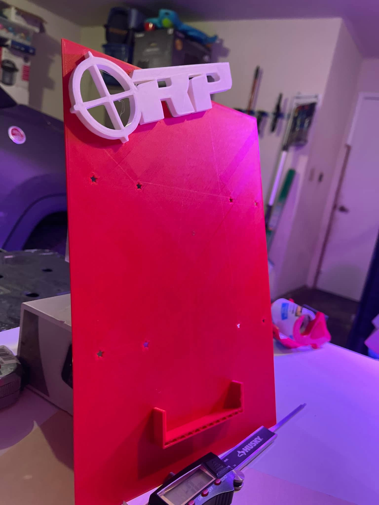 Red and white fabricated display prototype during fit and finish work